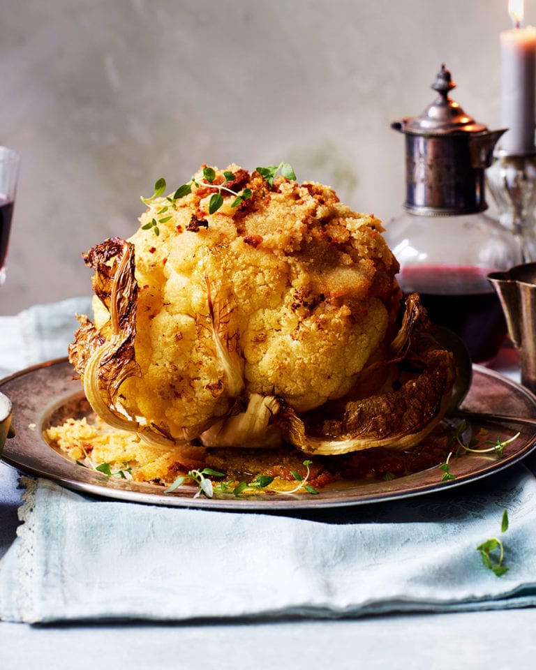 Whole roasted cauliflower with leeks and cheese sauce