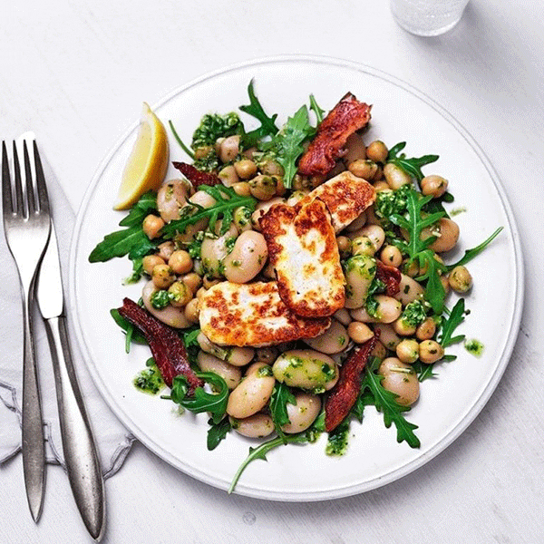 Warm pesto, chickpea and butter bean salad with halloumi