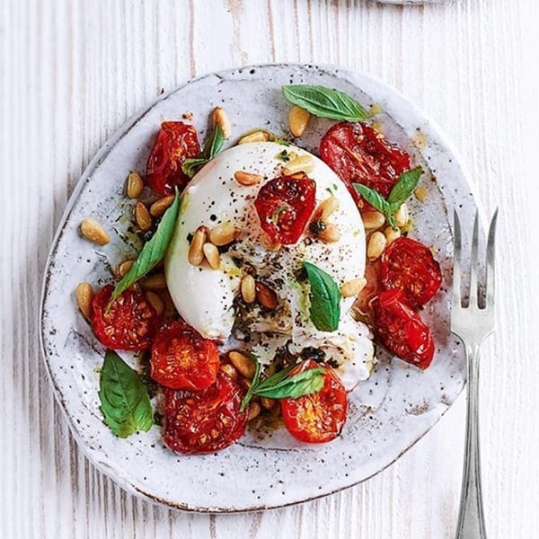 Burrata with sticky roasted tomatoes, pine nuts and basil