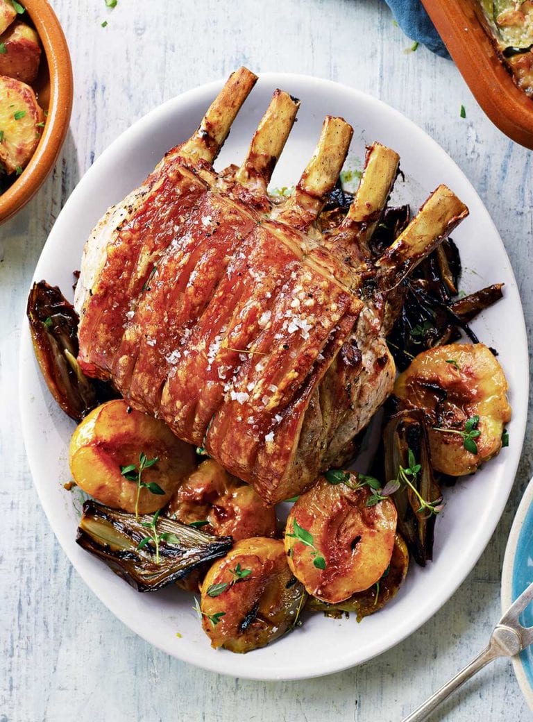 Roast pork with peaches, garlic roast potatoes and courgette gratin