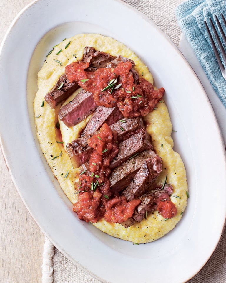 Steak with polenta and tomato and caper sauce