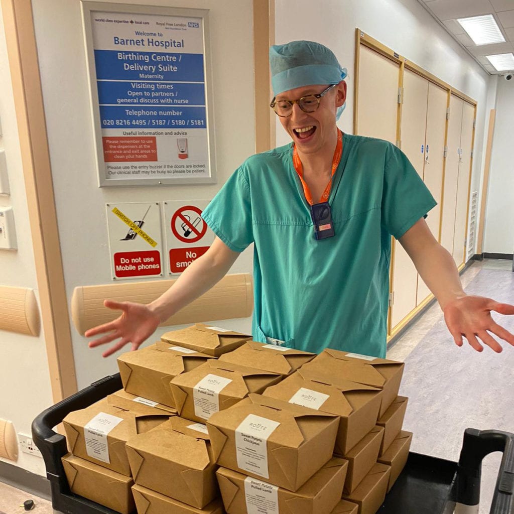 A member of staff at Barnet Hospital welcomes a food delivery