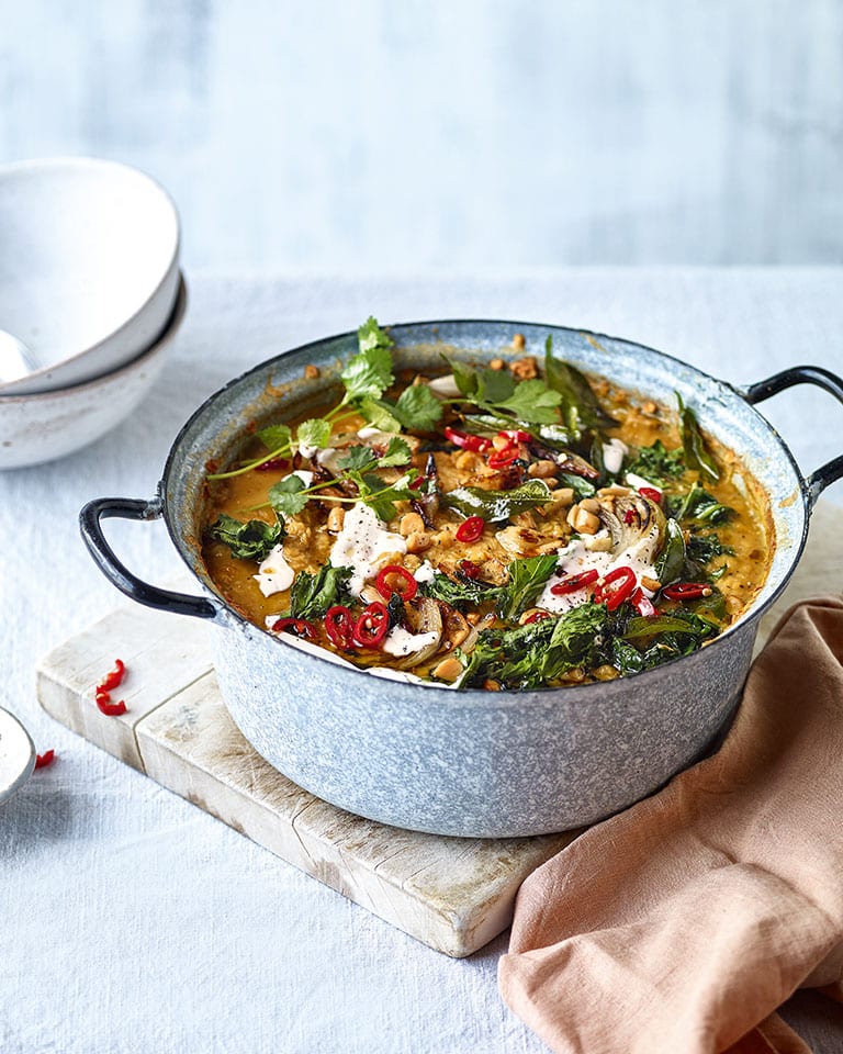 Curried lentil soup with kale and almond topping