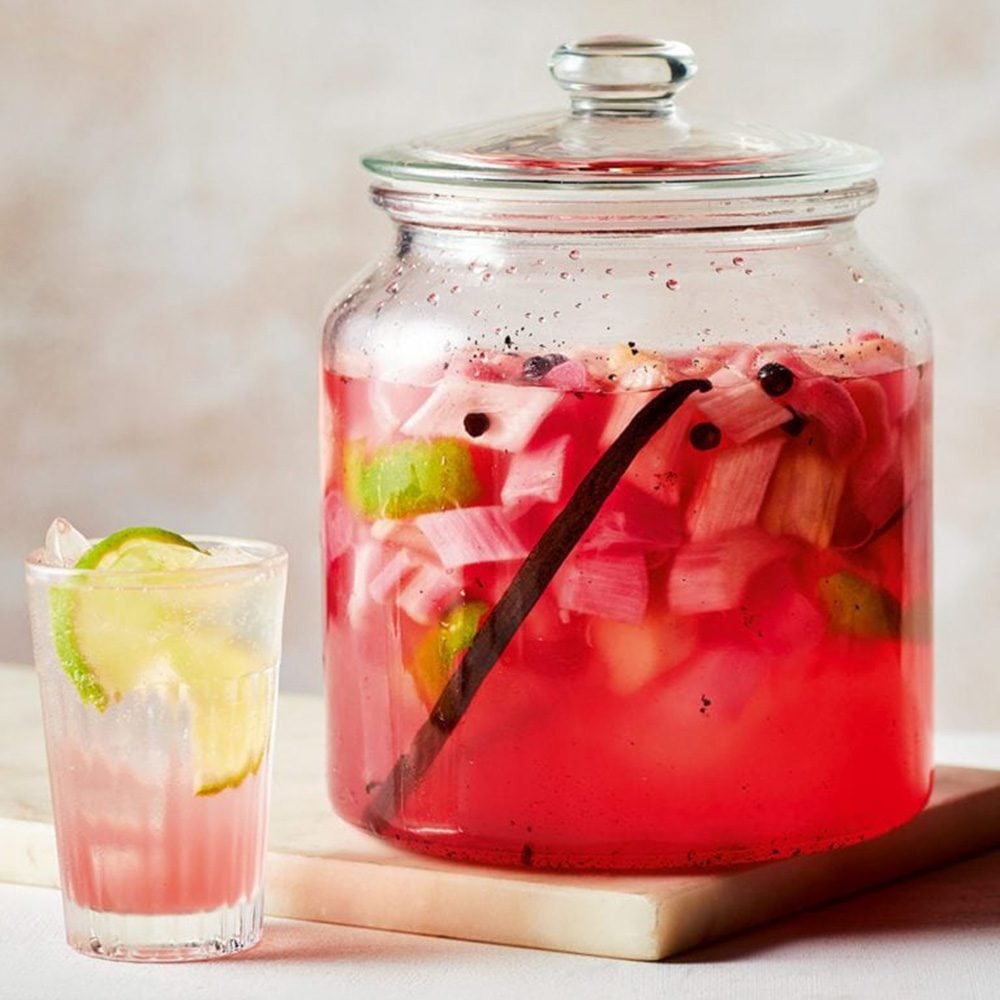 A glass jar of gin infusing with rhubarb