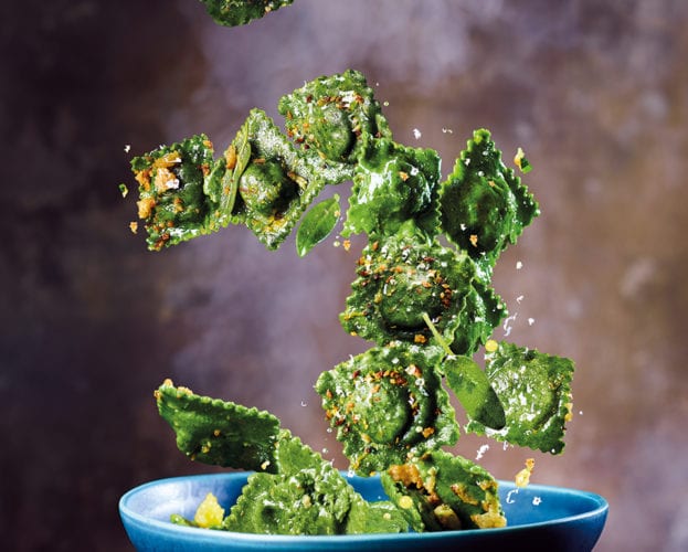 a bowl of vibrant green wild garlic ravioli