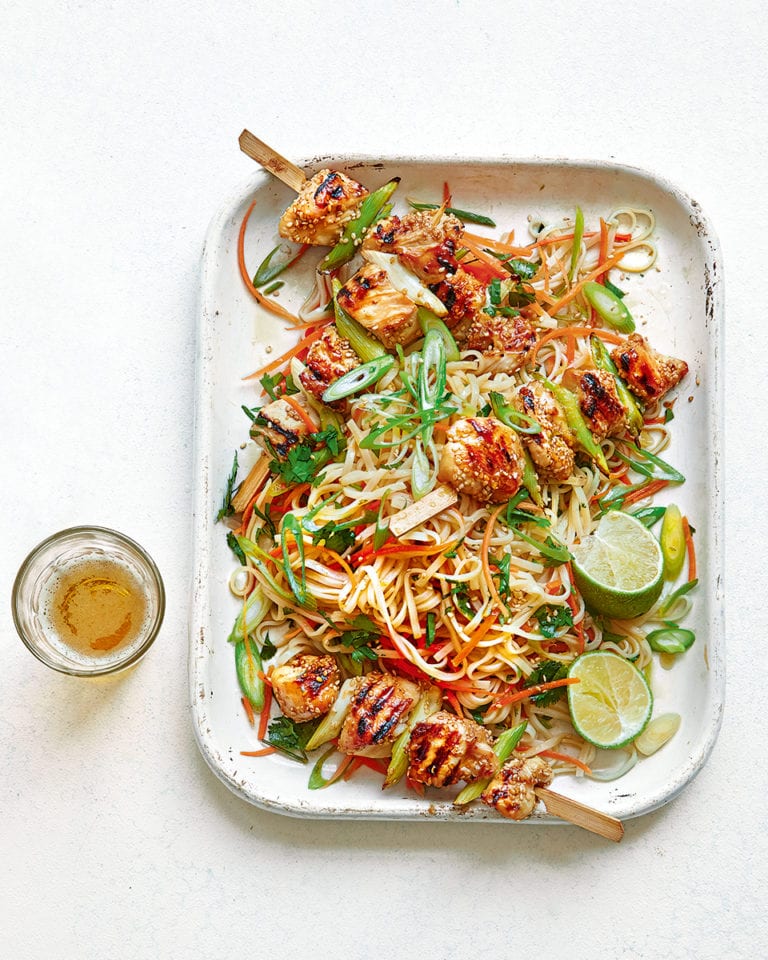 Sticky sesame chicken skewers with noodle salad