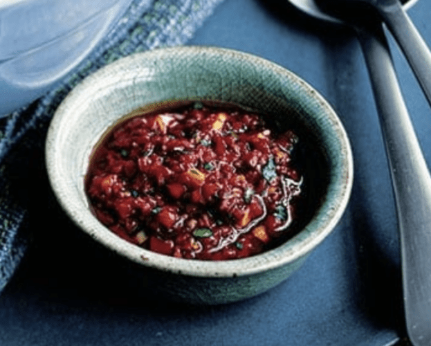 A small bowl containing harissa dressing