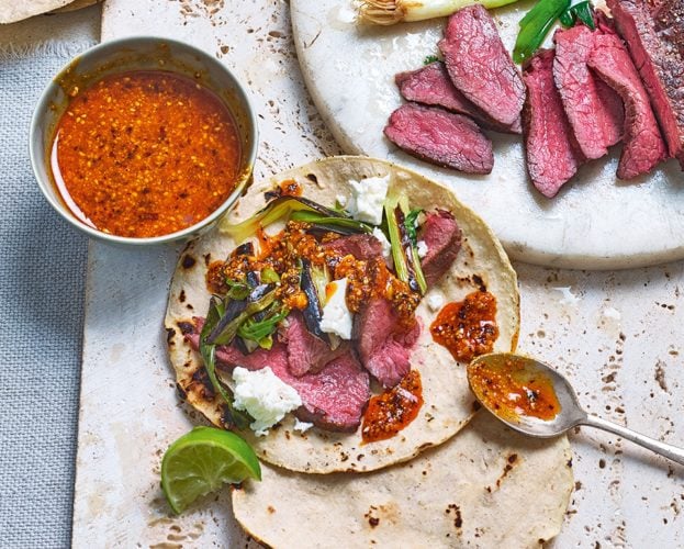 Venison tacos with grilled spring onions and peanut salsa