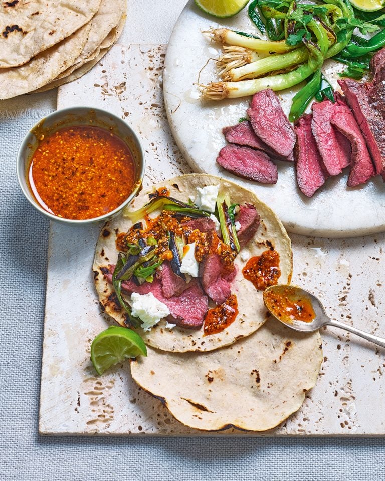 Venison tacos with grilled spring onions and peanut salsa