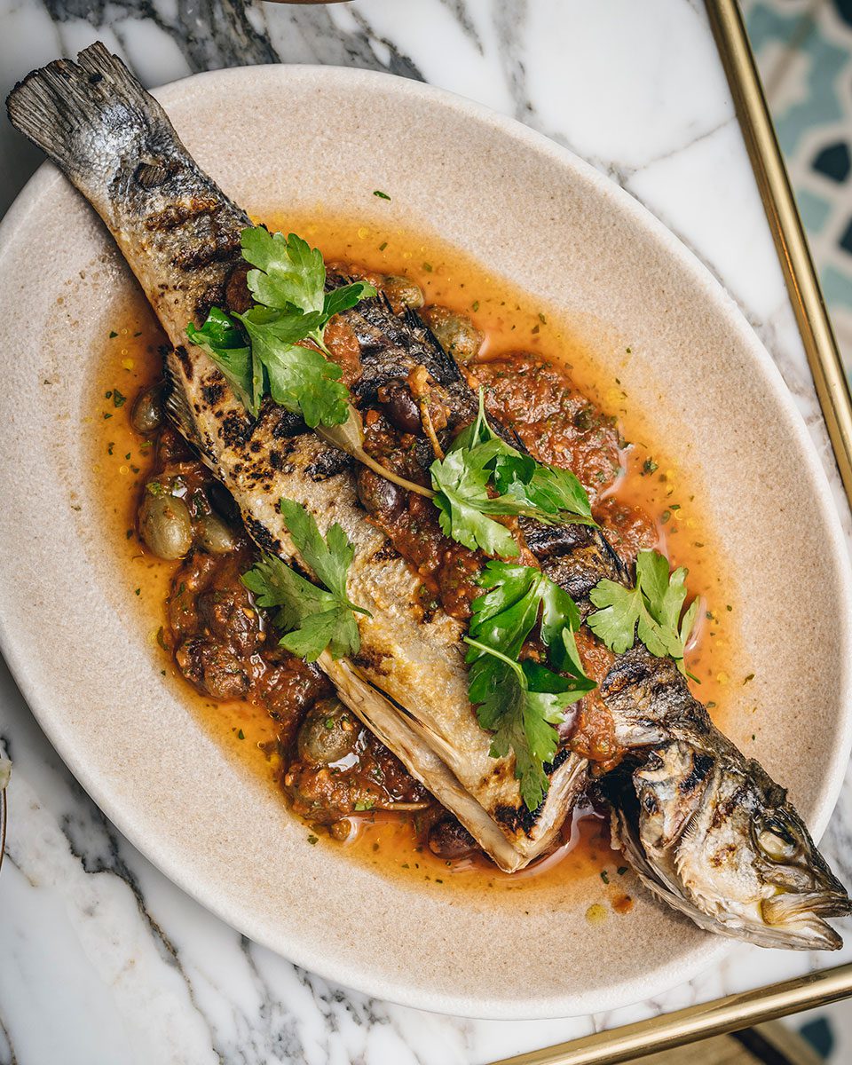 Italian whole sea bass with tomato sauce delicious. magazine