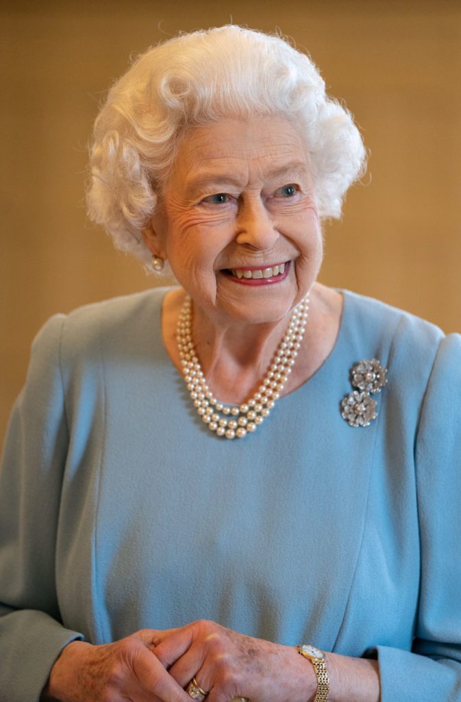 Britain's Queen Elizabeth II smiles during a reception in the Ballroom of Sandringham House, the Queen's Norfolk residence on February 5, 2022