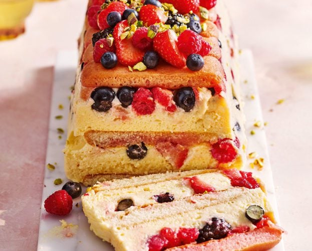 Sliced limoncello and berry trifle cake