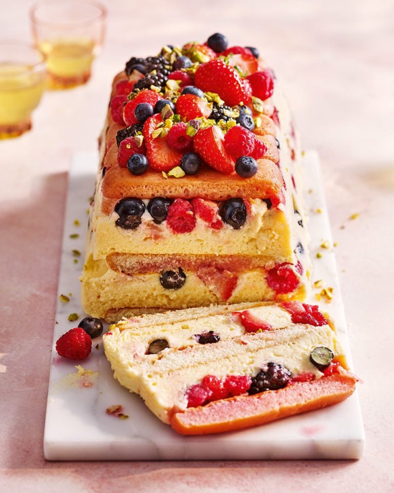 Sliced limoncello and berry trifle cake