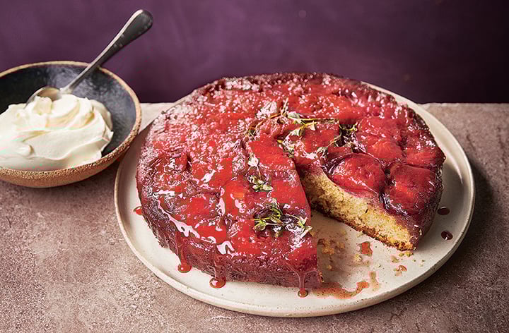 Plum upside down cake, shown with a slice taken out