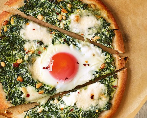Spinach and egg pizzas