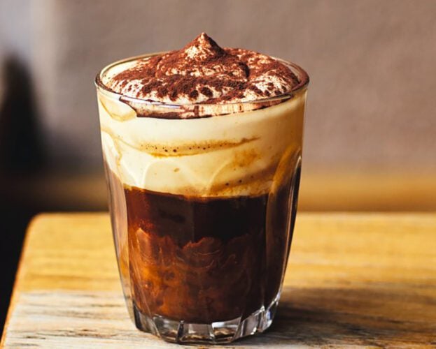A glass of bicerin - espresso topped with melted chocolate and whipped cream