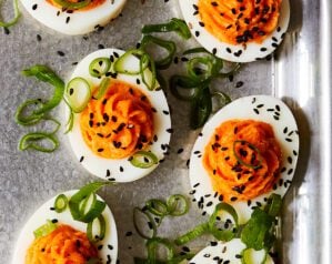 Devilled eggs topped with spring onions and black sesame seeds