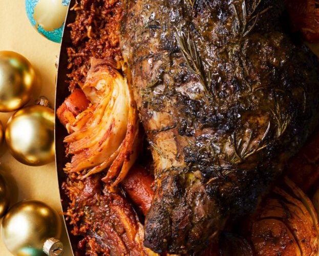 Tamarind and herb-stuffed lamb leg on a bed of jollof rice