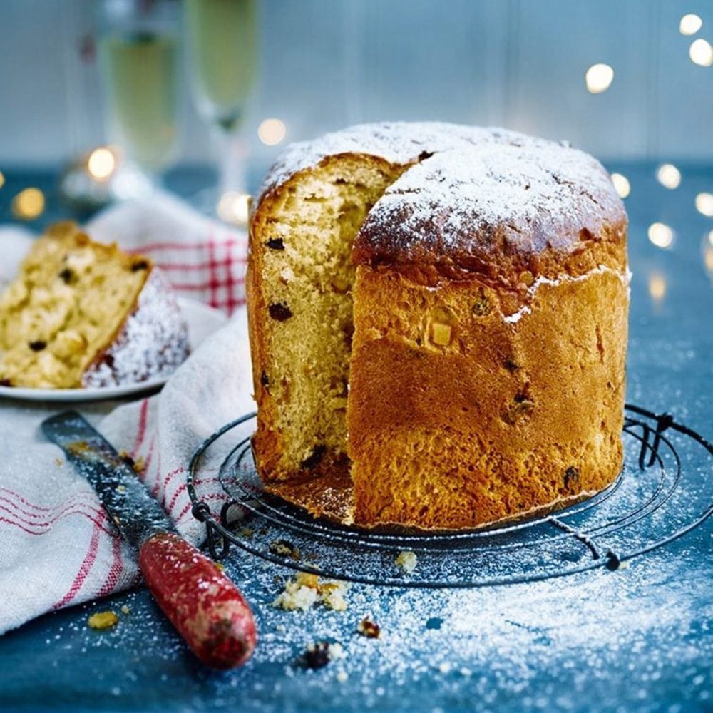 A tall panettone with a slice removed