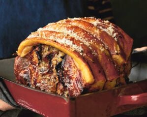 Slow-cooked shoulder of pork in a roasting tray topped with crackling