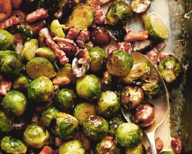 A roasting tray of brussels sprouts with bacon lardons and chestnuts