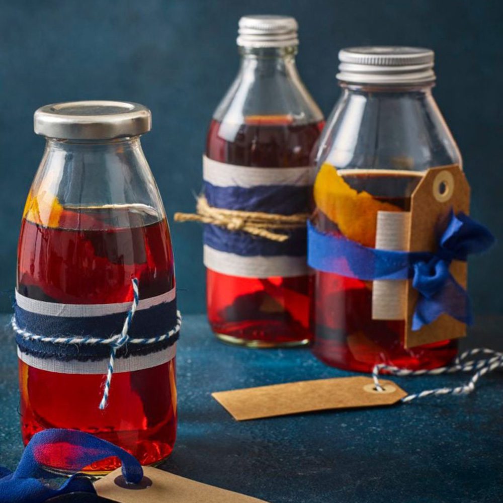 Three bottles of negroni, wrapped with ribbon, for Christmas hamper ideas