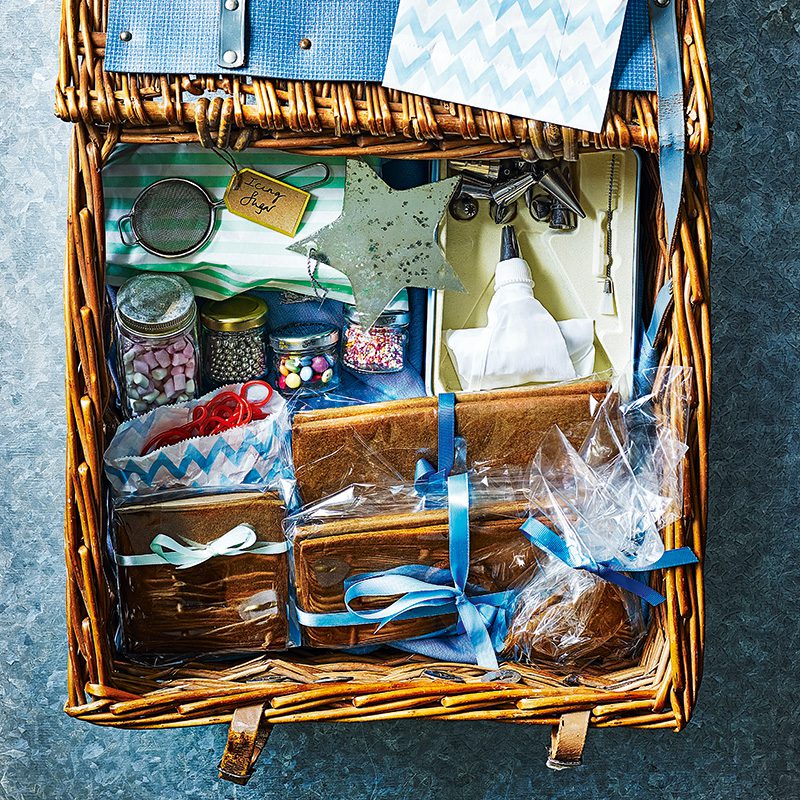 A hamper containing components to make a gingerbread house for Christmas hamper ideas