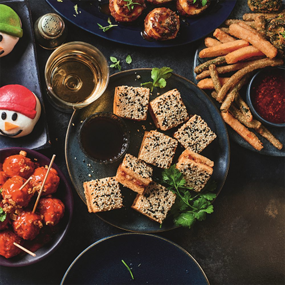 Mini prawn toasts topped with black and white sesame seeds