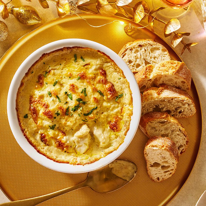 A pot of smoked haddock rarebit with bread on the side