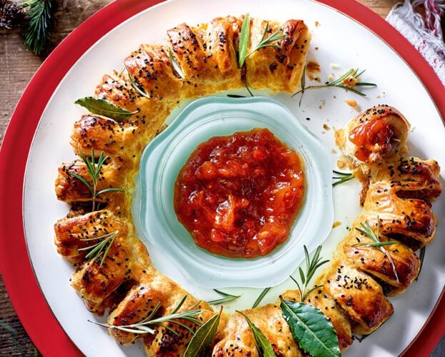 A sausage roll wreath with tomato dip in the centre