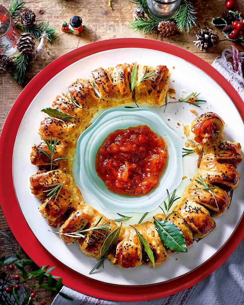 A sausage roll wreath with tomato dip in the centre