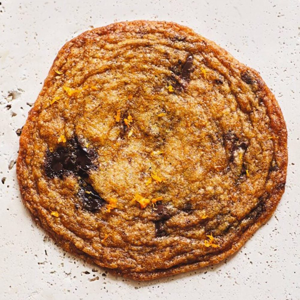 A close up of a large chocolate chip cookie