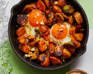 A cast iron past of brussels sprout hash with two eggs