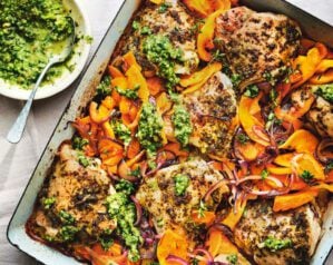 A chicken traybake with squash and bright green chimichurri sauce
