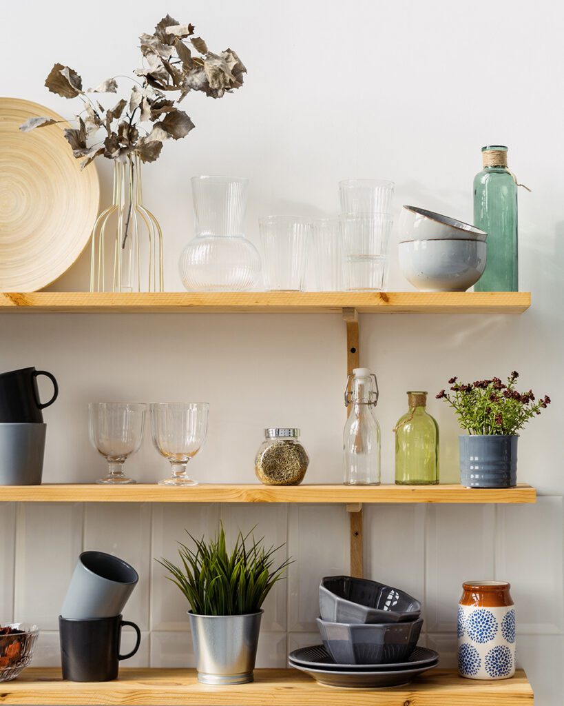 An Instagrammable kitchen design featuring wooden shelves with crockery and glassware