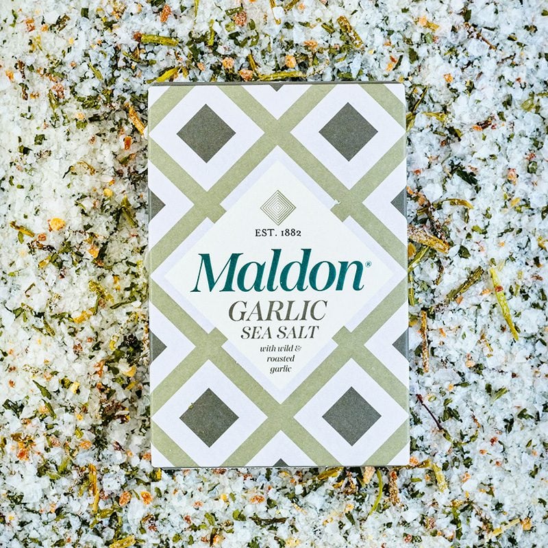 A box of Maldon garlic salt on a bed of garlic salt
