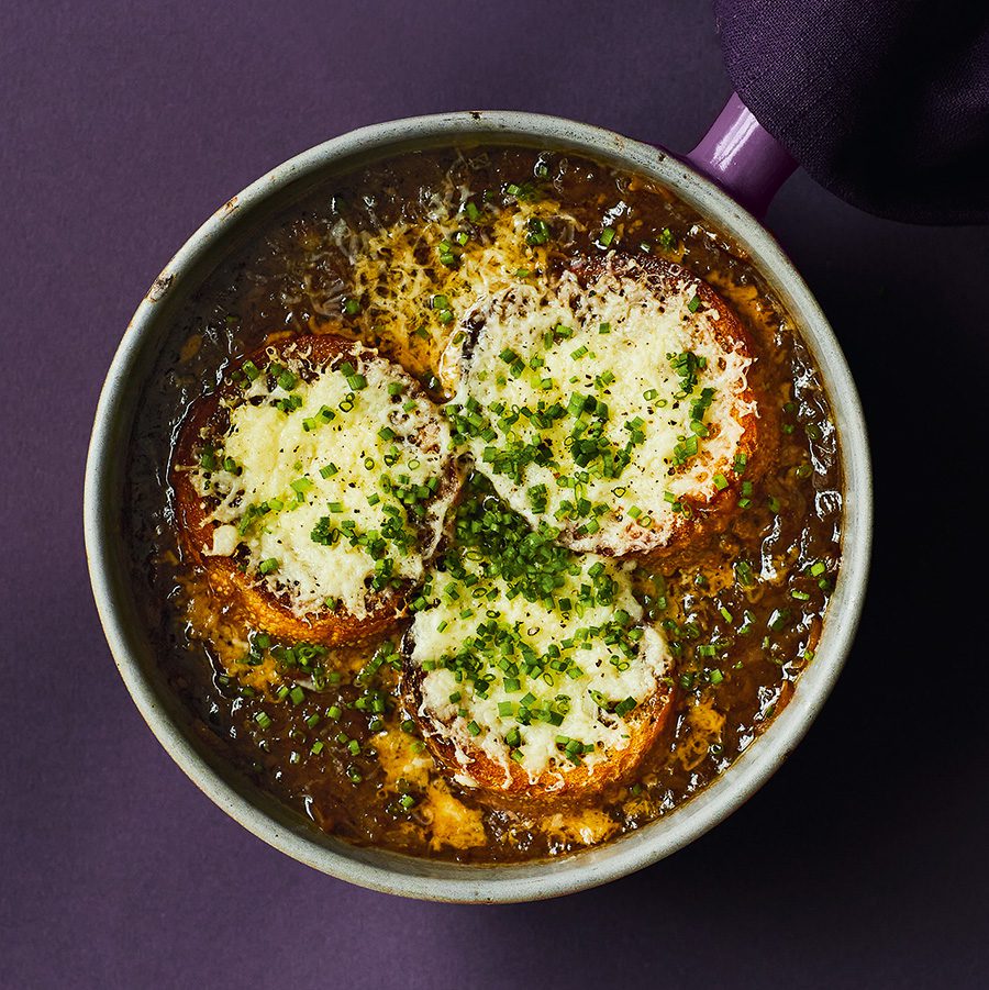 A bowl of French onion soup topped with cheesy toasts