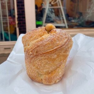 A sugar-encrusted cruffin on white paper