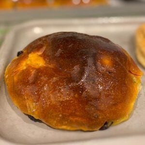 A very bronze bun, with dried fruit peeking out