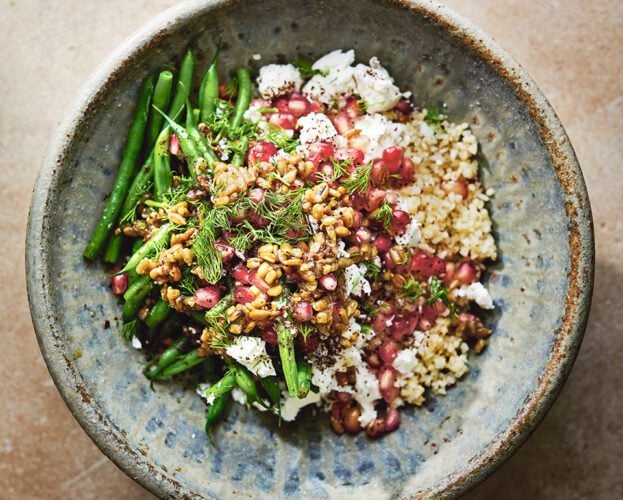 Green beans, bulgur, feta and pomegranate with sunflower seed dressing