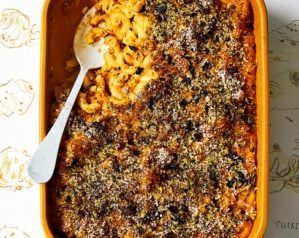 Vegan celeriac mac and cheese in an oven dish with a spoonful removed