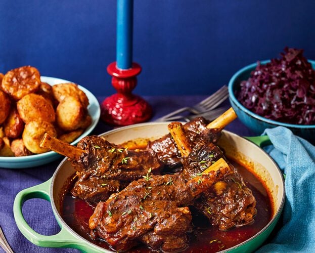 Curried lamb shanks with roast potatoes and red cabbage