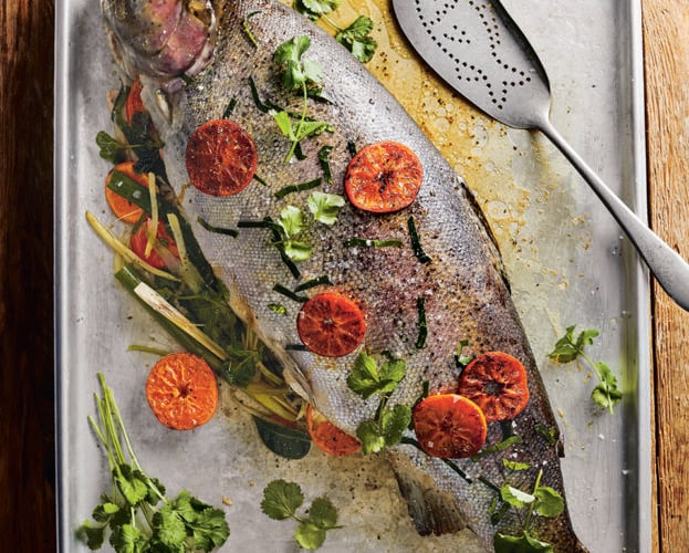 Roast trout with clementine, ginger, spring onion and herbs