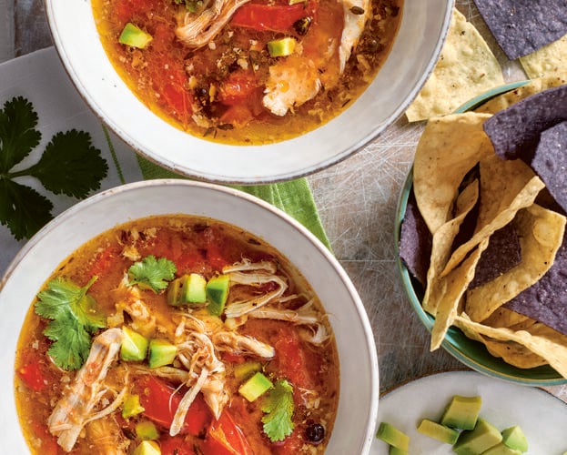 Slow cooker citrus chicken broth with tortillas and avocado