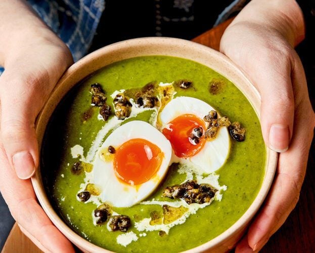 Leek and spring greens soup with soft eggs and crispy capers