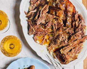 Slow-cooked orange wine lamb shoulder with shallots