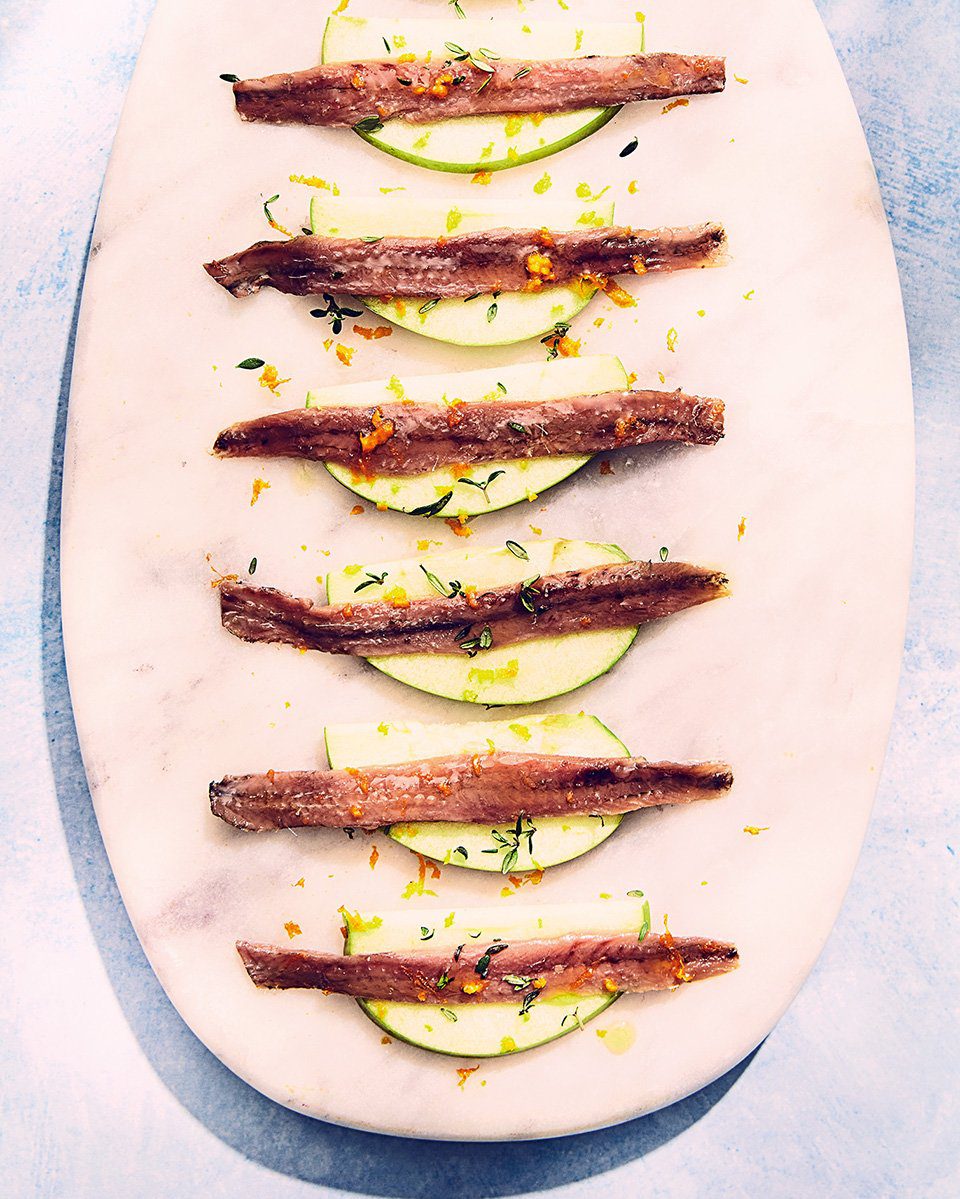 Tinned anchovy canapés with apple and orange